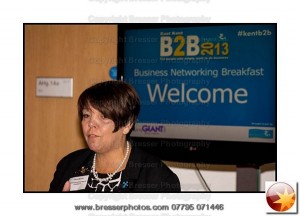 Carole Baron from Kent Invicta Chamber of Commerce speaking in front of LCD monitor