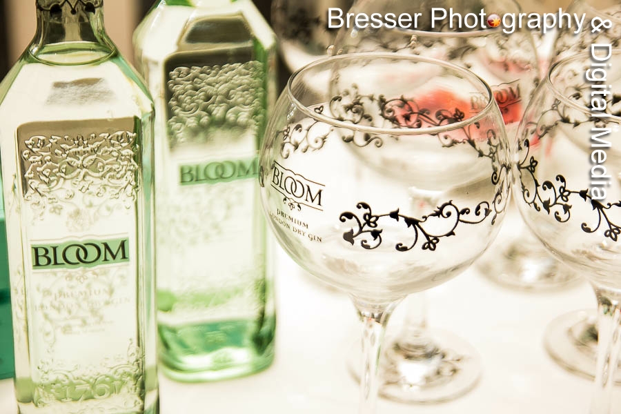 Bottles of Bloom branded gin with large goblet glass in foreground