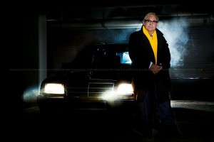 commercial portraits - photograph of man and car in moody dark surroundings