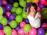 Business Portrait of a woman standing out from balloons