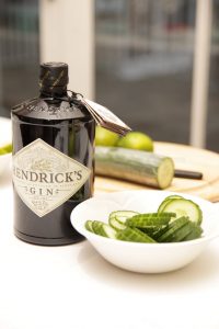 Henrick's gin and bowl of sliced cucumber