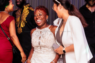 Two women dressed for a party laughing and clearly enjoying themselves