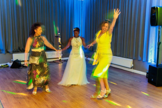 Three women dancing together with gay abandon