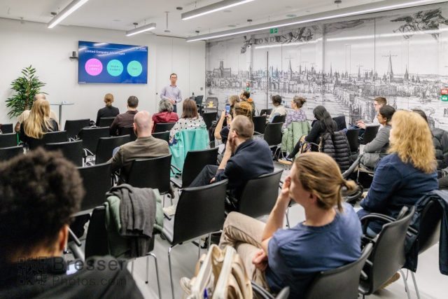 135A0621 Accountant, James Huang presenting to a room full of business people