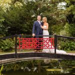 Wedding Couple pose on a bridge