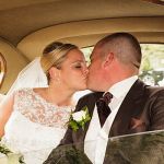 Sneaky snog in the back seat for this newly married couple