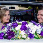 Bride and Groom look back from their wedding car