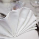 Napkin fanned table setting at wedding breakfast
