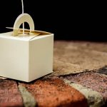 Close up of a small box as a balloon weight on the bride's front door step