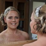 Bride looks out from the mirror reflection before her marriage