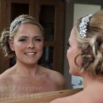 Bride looks out from the mirror reflection before her marriage