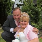 Loving couple pose for a formal wedding photo