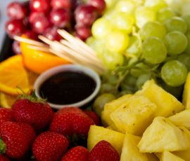 Close up of a fruit platter made from; strawberries, grapes and pineapple and orange slices.