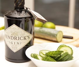 Henrick's gin bottle and bowl of sliced cucumber