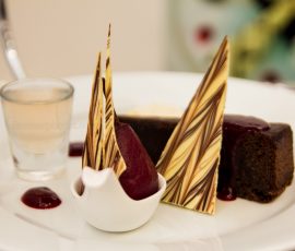 Close up of stylised dessert with chocolate shards and brownie