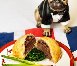 British Bulldog model eyes an individual Beef Wellington served with greens and wine jus