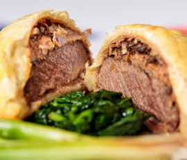 Close up of a Beef Wellington opened to see the succulent meat