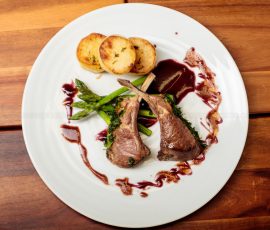 Lamb chops, potatoes and asparagus shot from above directly down over the plate